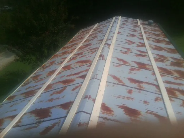 Rusted metal roof panels with new wood purlins before replacement — Storm Damage Roof Repair in Fort Monroe by Roofing Brothers